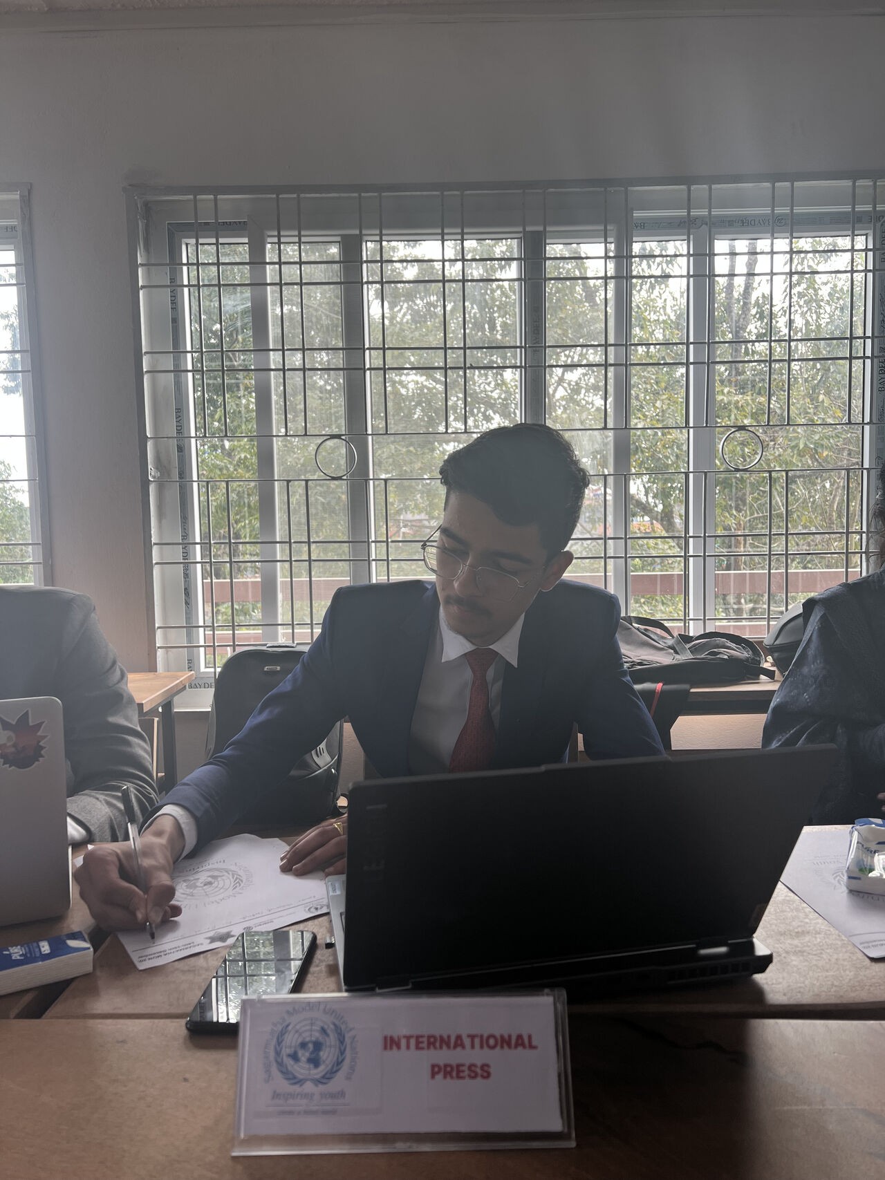 Samir Bhandari working during a formal student event